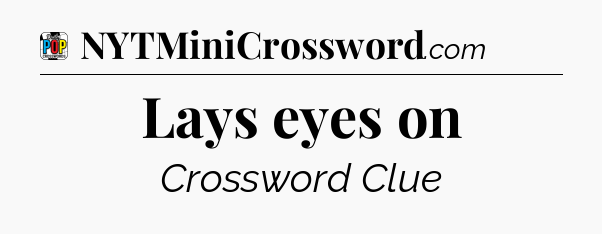 Lays eyes on Crossword Clue