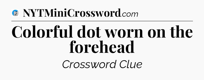 Colorful dot worn on the forehead Crossword Clue